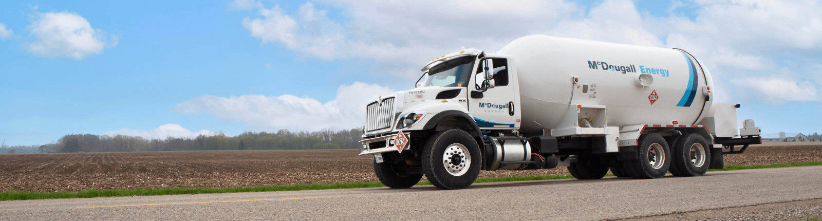 Clean energy delivery fuel truck for McDougall Energy services.