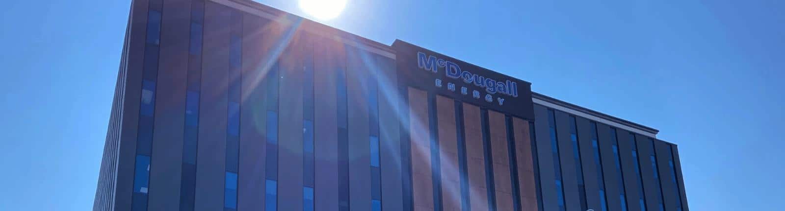 Sun shining on corporate building with many windows