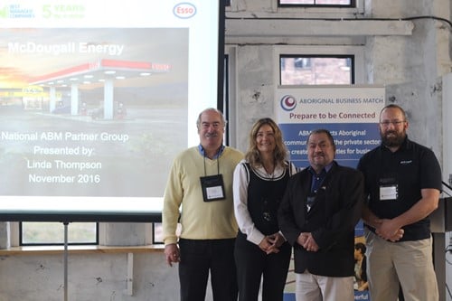 McDougall Energy Becomes National Partner to Aboriginal Business Match 188 Shows 4 people standing smiling standing in from of a projection screen