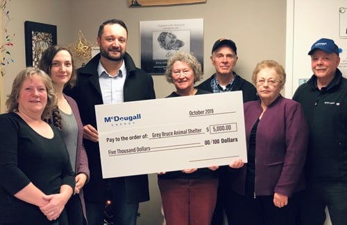 McDougall Energy Donates $5000 to the Grey Bruce Animal Shelter 158 Shows 7 people inside house holding a large cheque from McDougall Energy