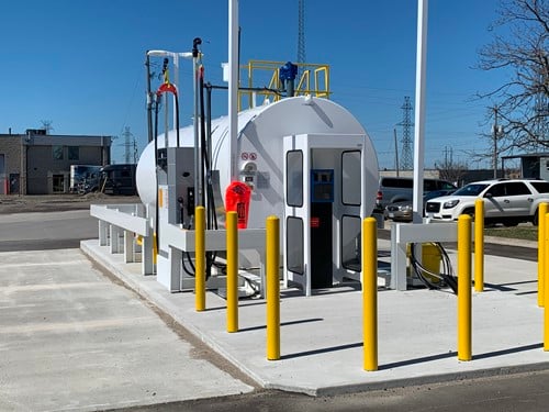 McDougall Energy brings high-quality Esso Diesel to Great Canadian Coaches 140 Show outside shot of large stationary fuel tank and yellow guard posts surrounding it