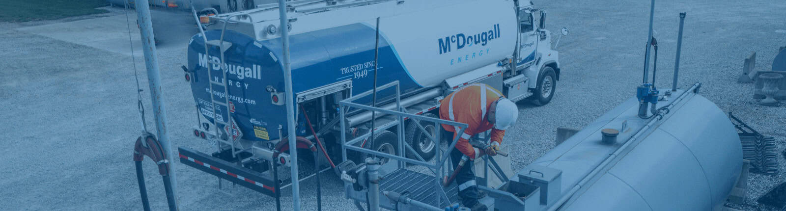 McDougall Energy fuel truck driver safely fuelling up a bulk tank