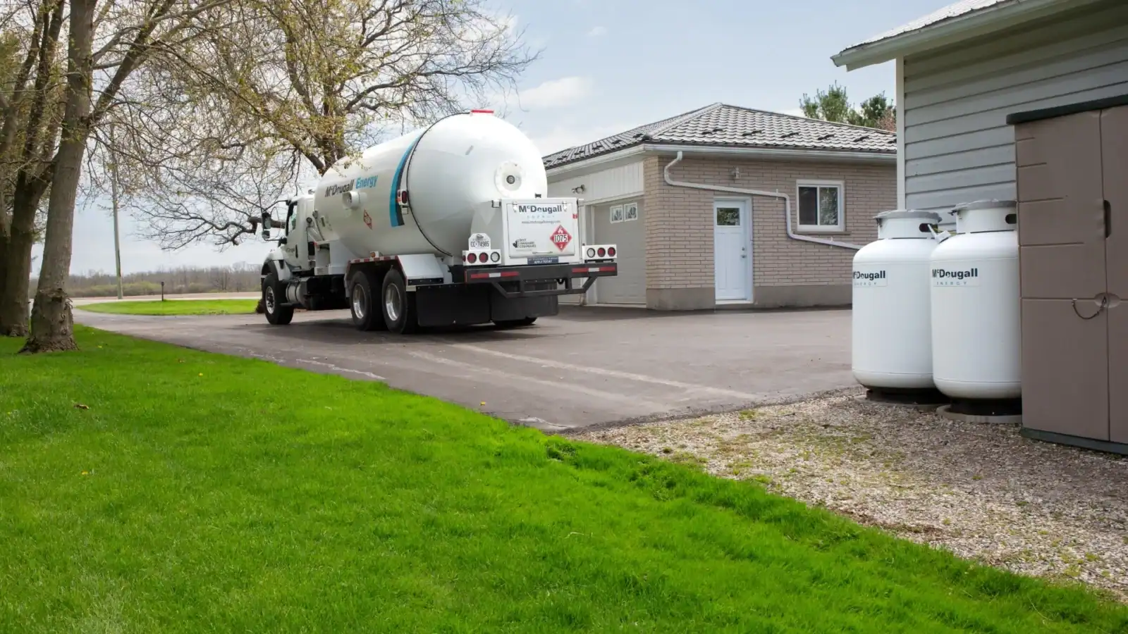 Fuel delivery truck at a residential home, providing propane from McDougall Energy.