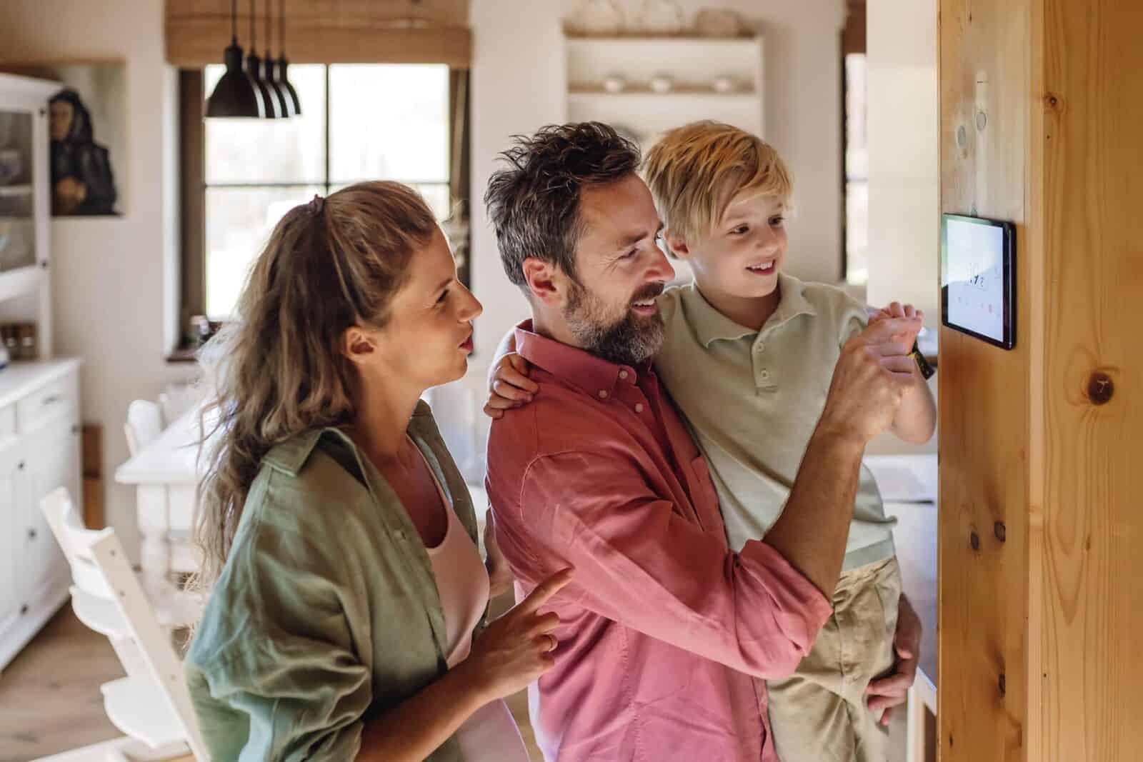 Family looking at a thermostat