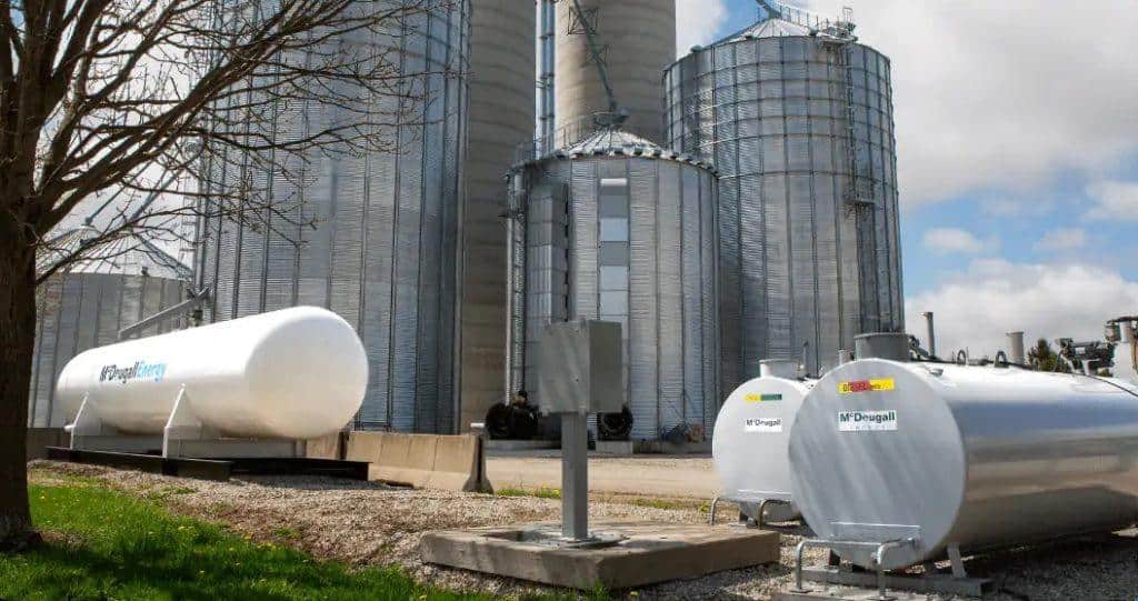 Fuel storage tanks at McDougall Energy facility, promoting oil and energy solutions.