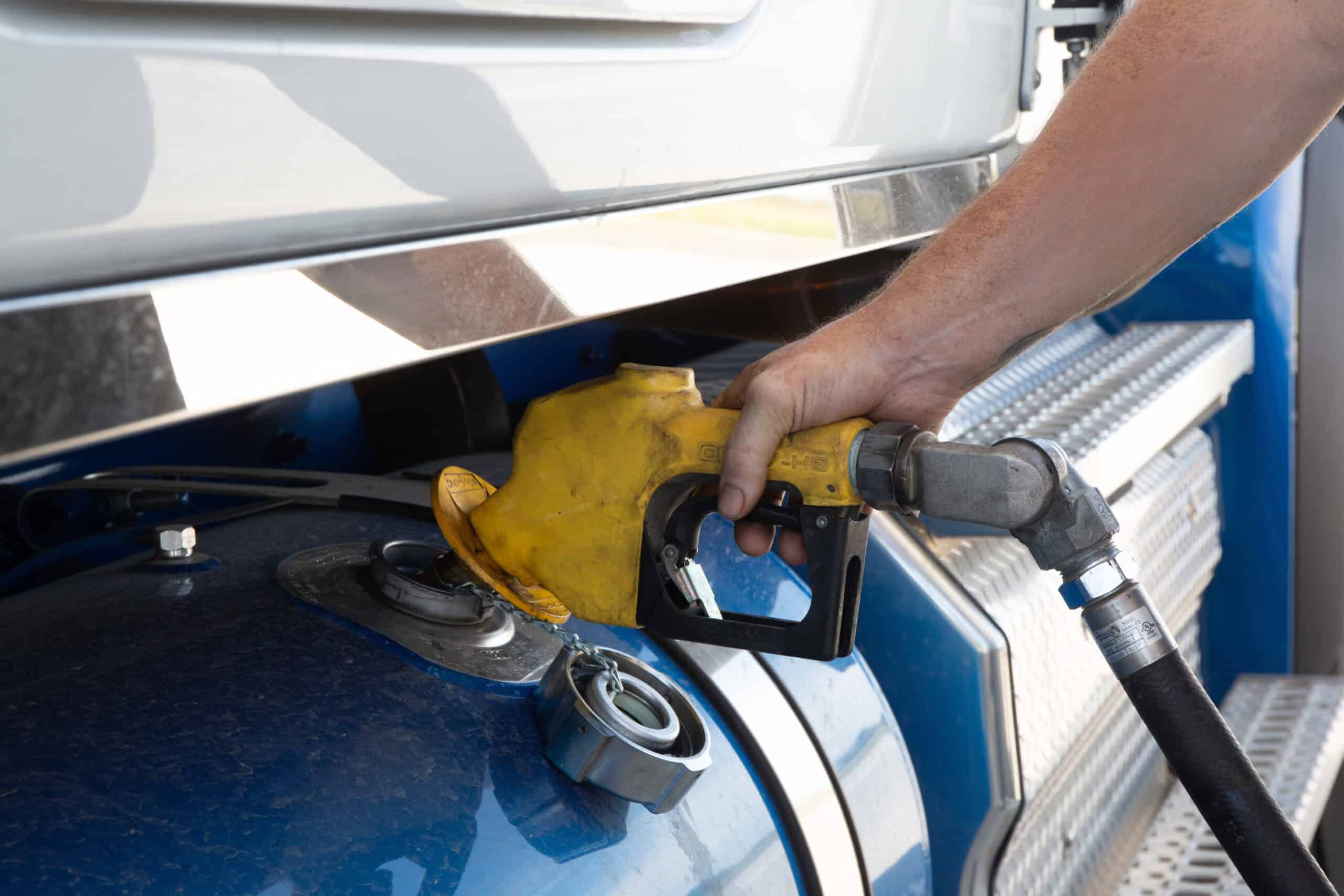 Fueling a commercial truck with diesel fuel at a truck stop.