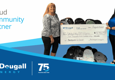 Photo of McDougall Energy representative with the United Way for a cheque presentation