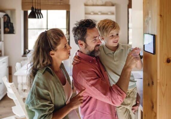 Family looking at a thermostat