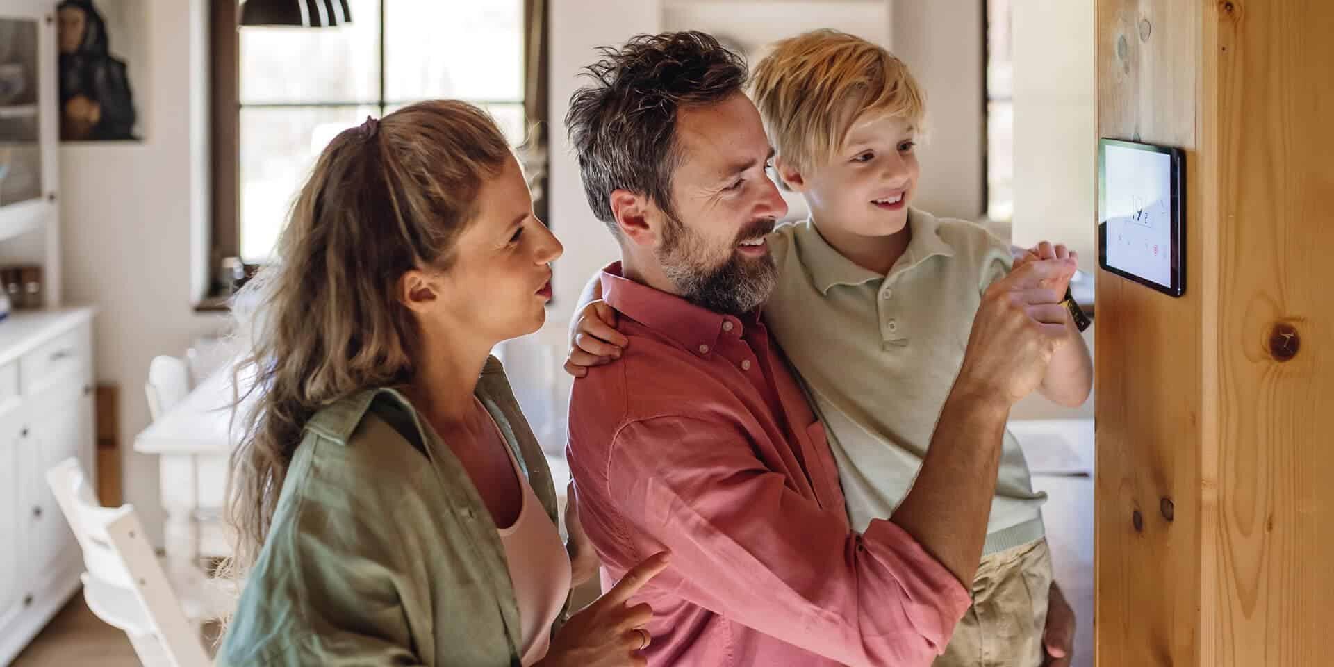 Family looking at a thermostat