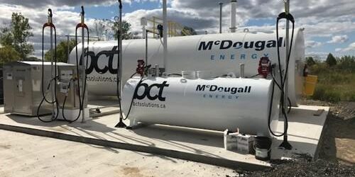 Shows outdoor shot of large white tank with Mcdougall Energy logo on it and BCT logo