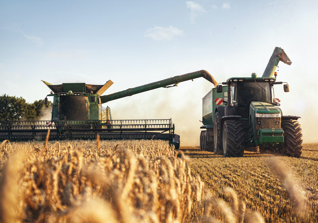Farming machine equipment in the field collecting wheat