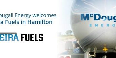 Shows back of a large chrome fuel truck with McDougall Energy logo and left of it is Vieira Fuels.