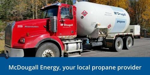 Shows outside image of a large red and white McDougall Energy fuel truck