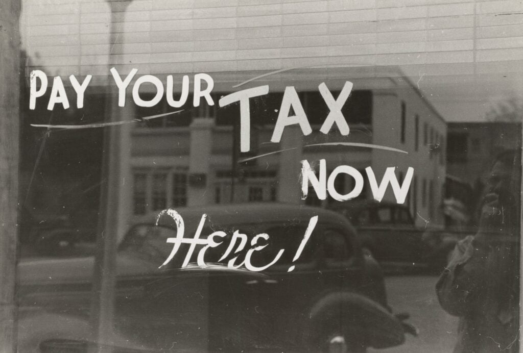 The Federal Carbon Tax and MEI – What you Need to Know 180 a sign that says pay your tax now here