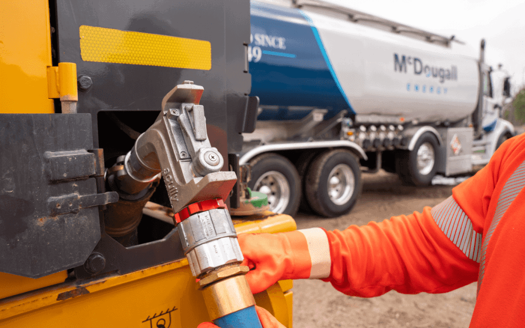 Fuel truck filling station with McDougall Energy fuel tank in an outdoor setting.